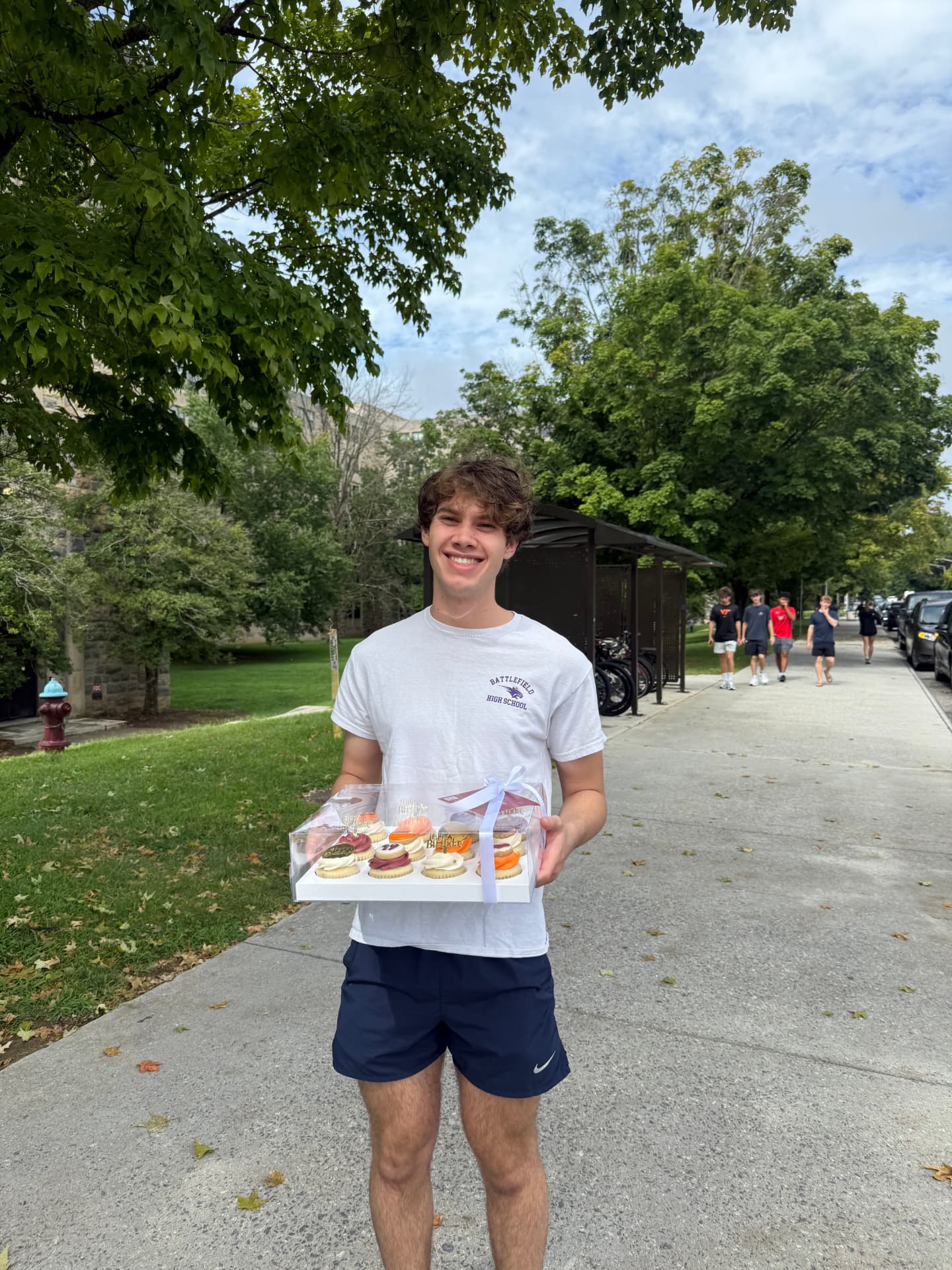 A student receiving a box of decorated cookies